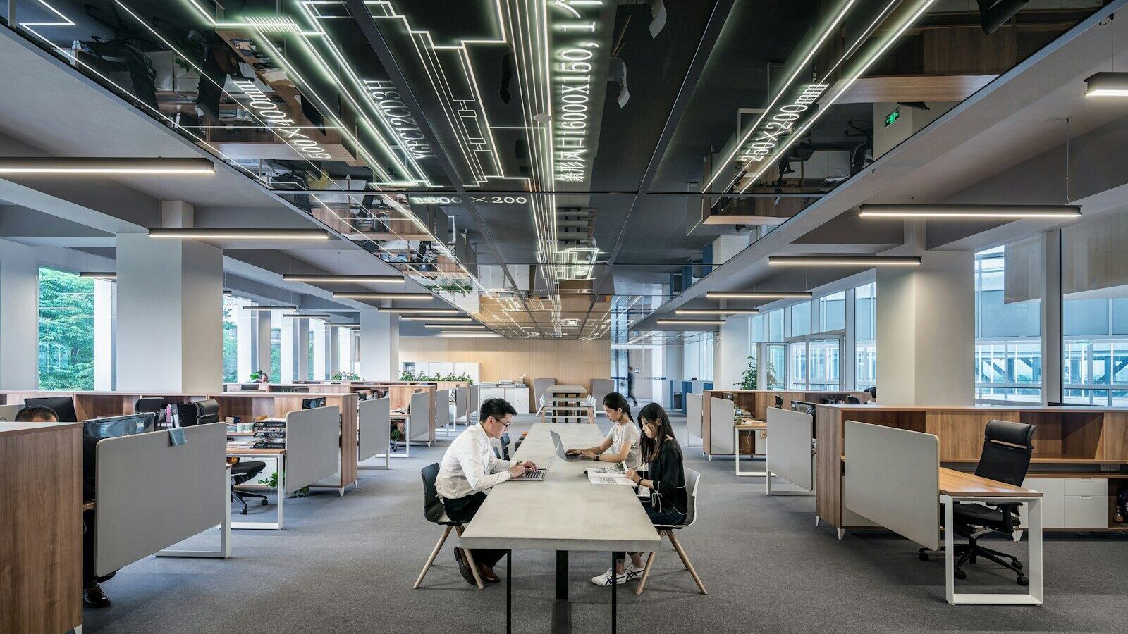 three people collaborating in open office