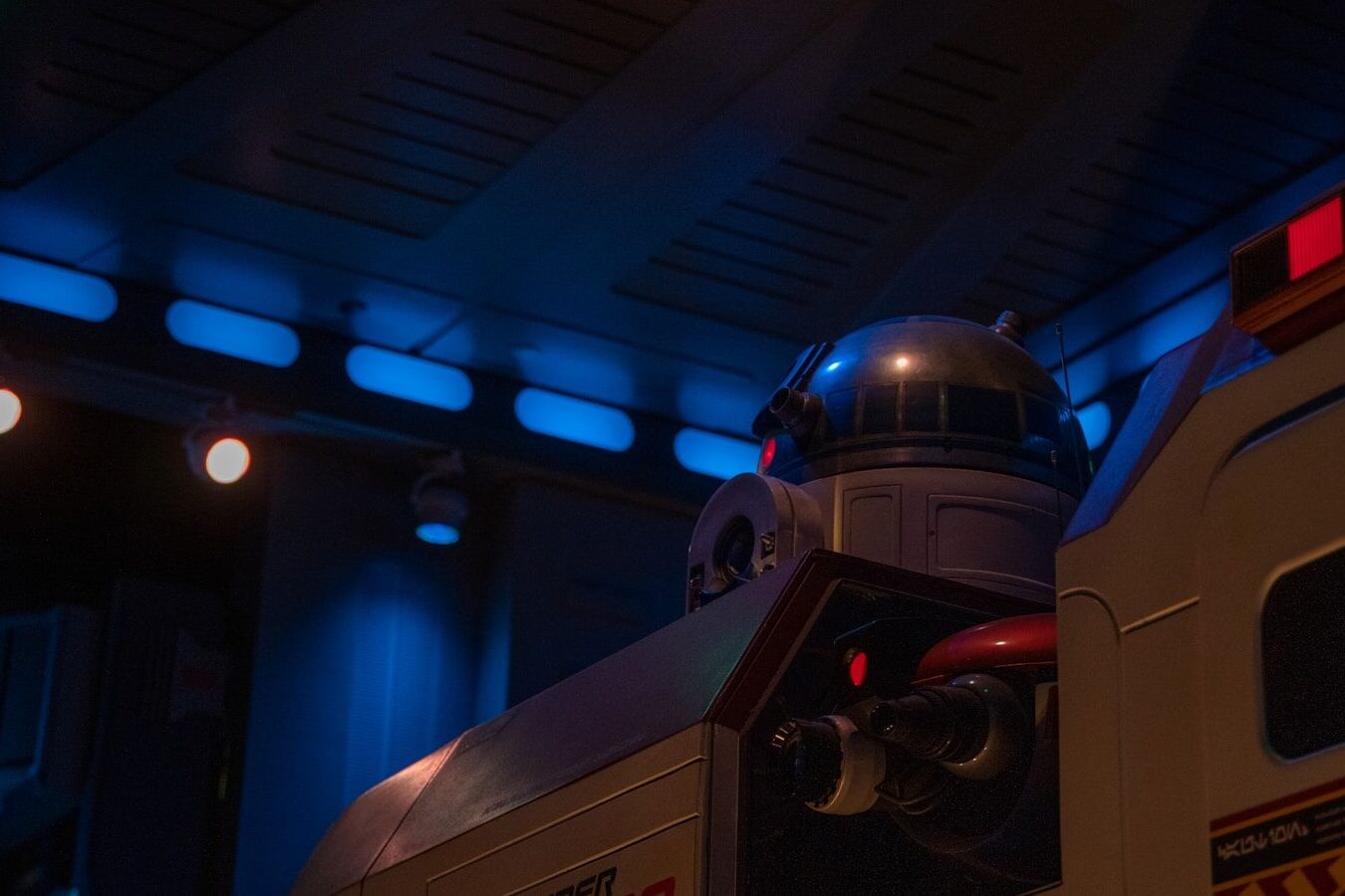 a close up of a robot next to a building