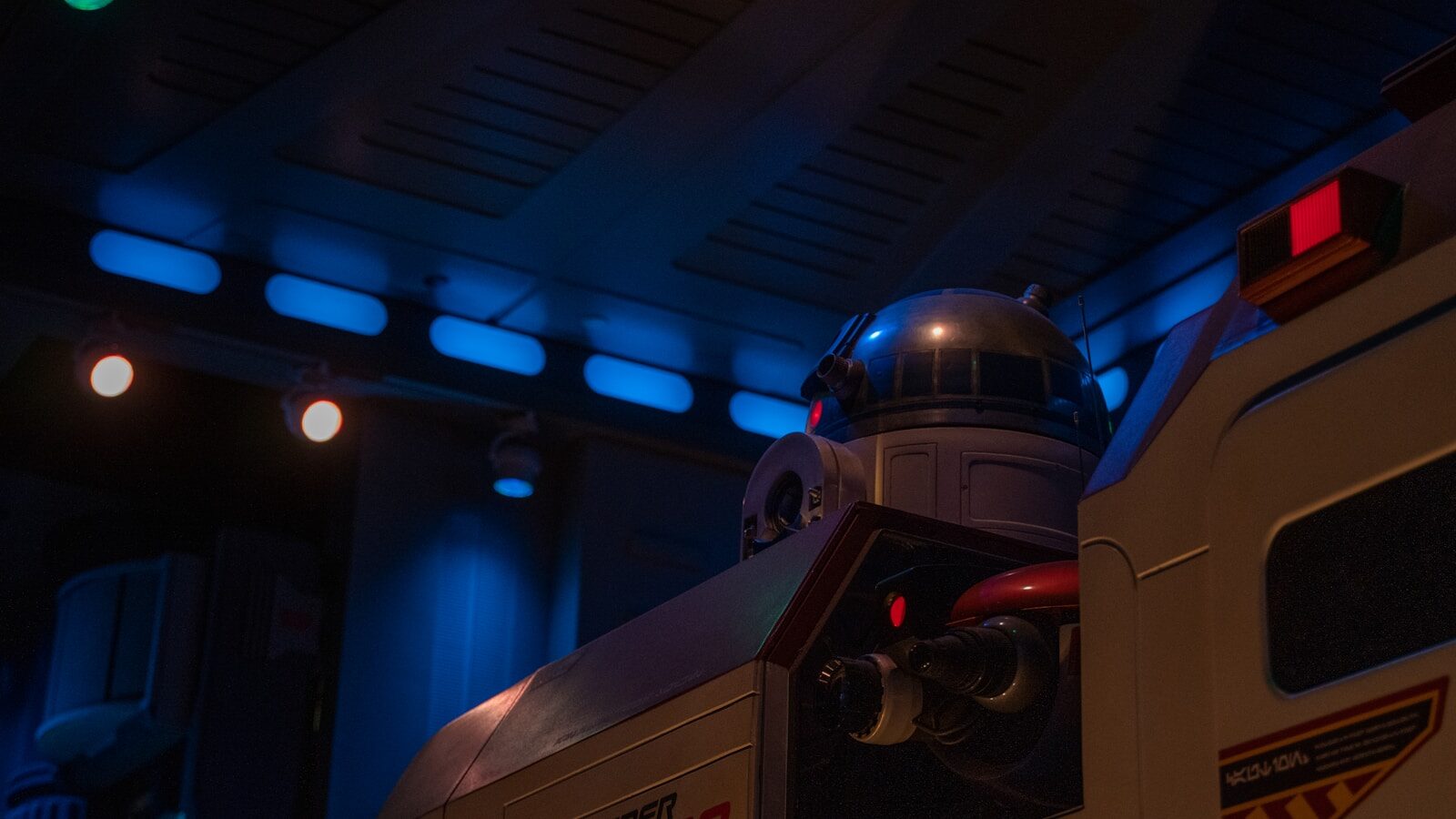 a close up of a robot next to a building