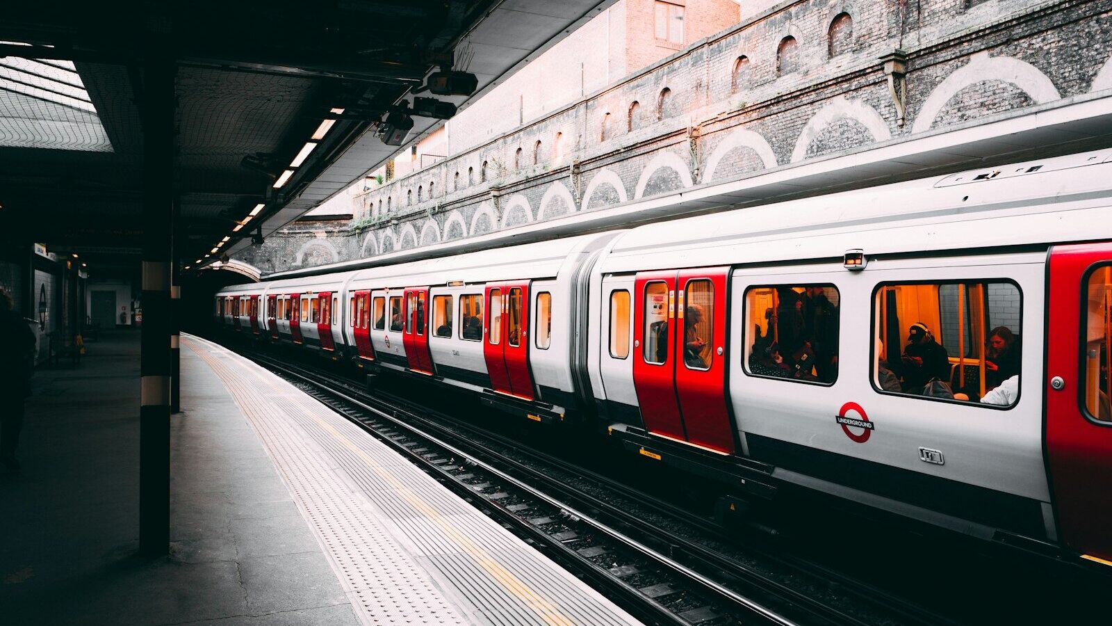 white and red train beside building at daytime
