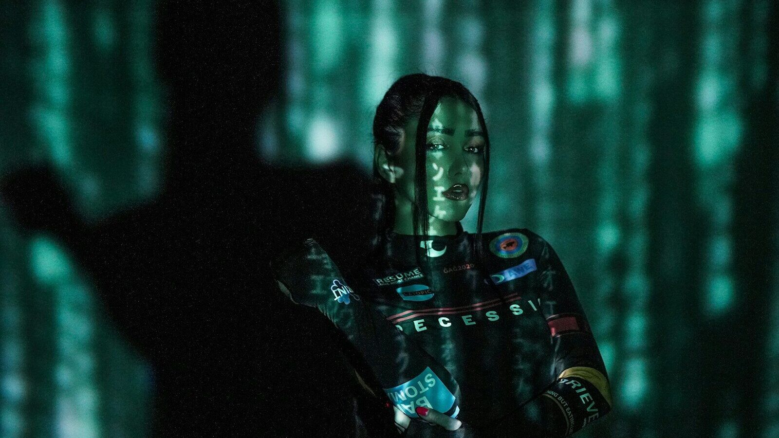 a man and a woman standing in a dark forest
