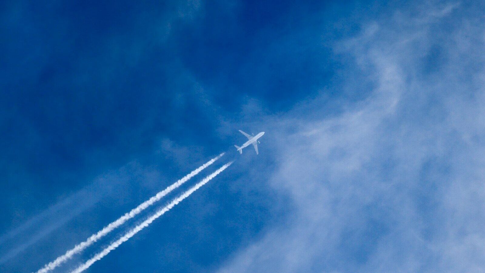 an airplane is flying in the blue sky
