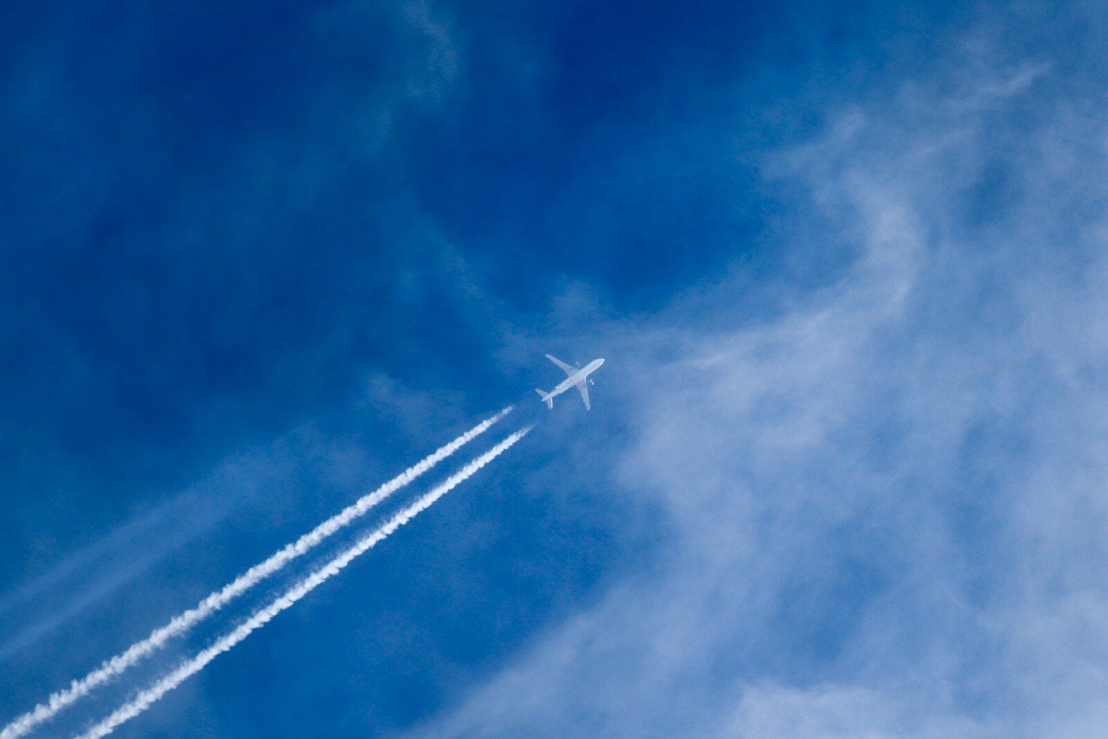 an airplane is flying in the blue sky