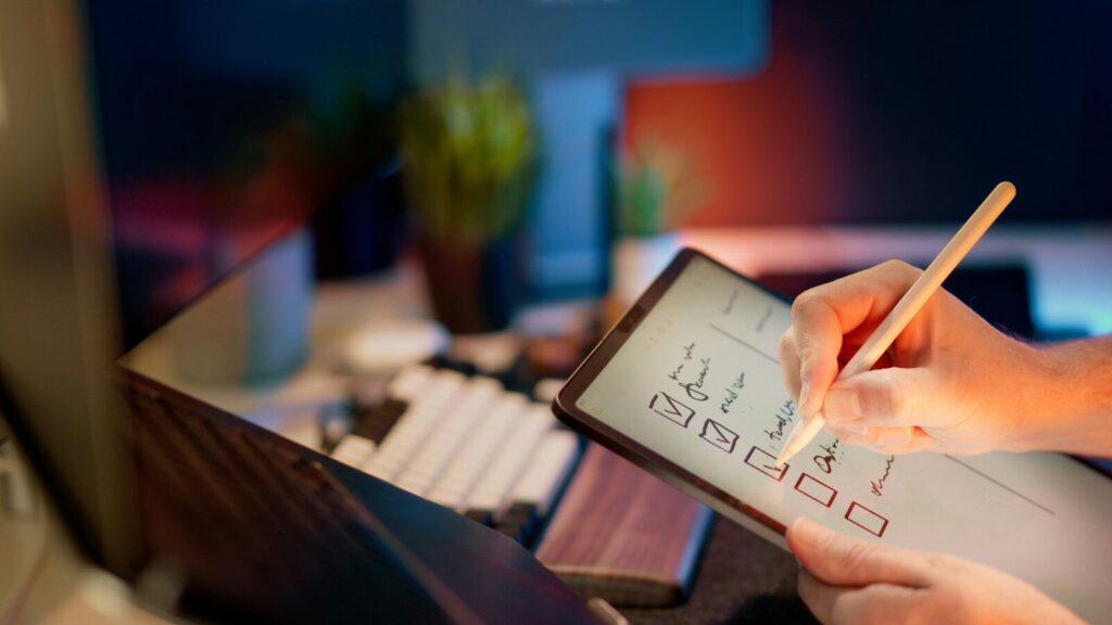 Someone is writing on a tablet with a stylus