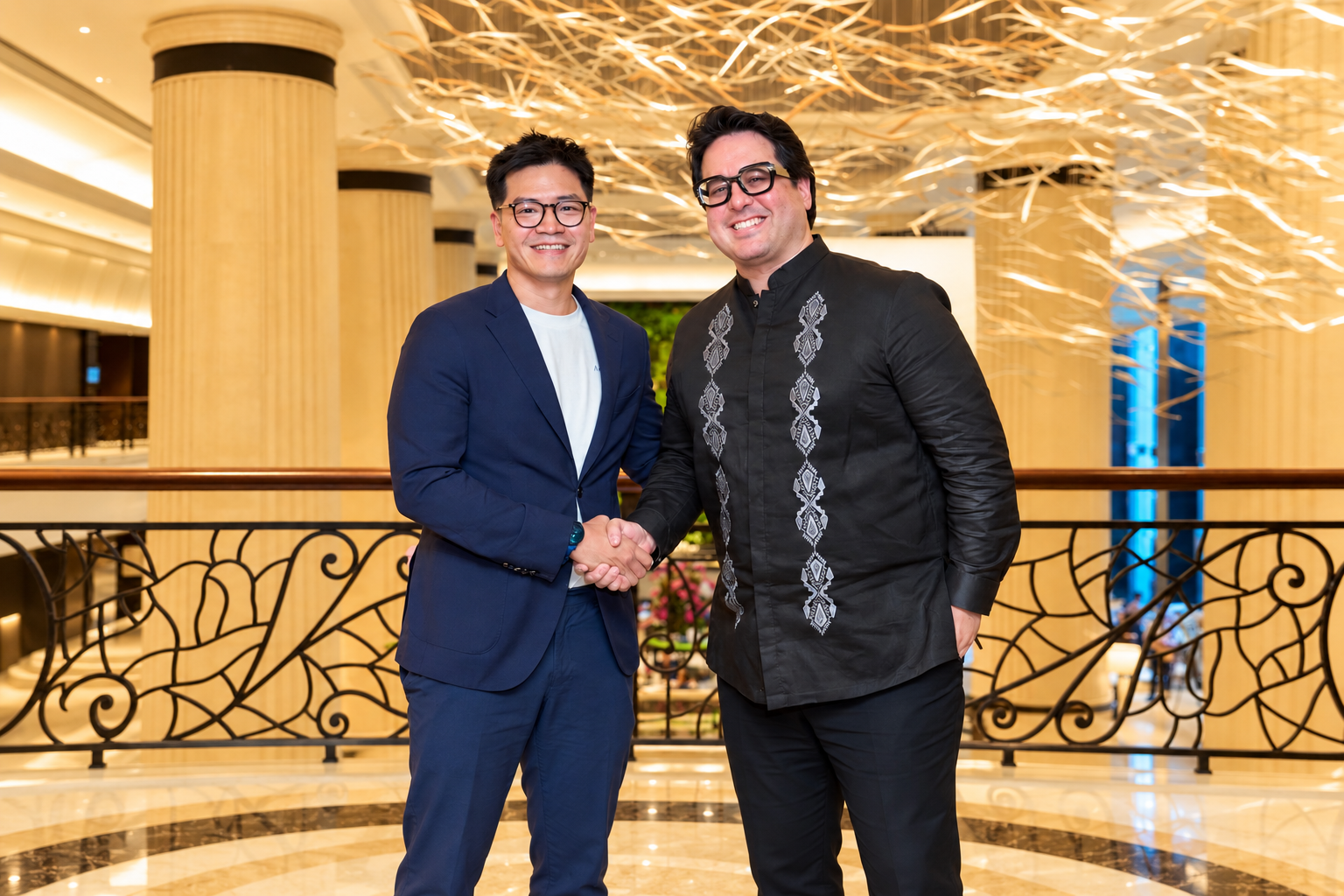 Aolani chief executive Nicholas Chia and YCO Cloud chief executive Nikolas Skalomenos de Ynchausti shake hands