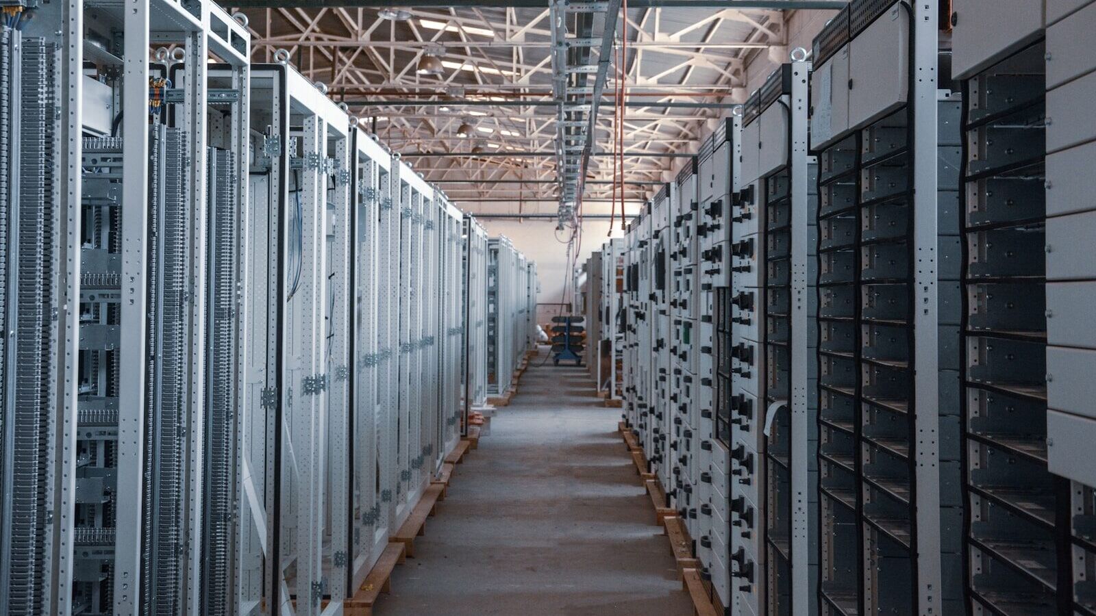 server room aisle with metal equipment racks