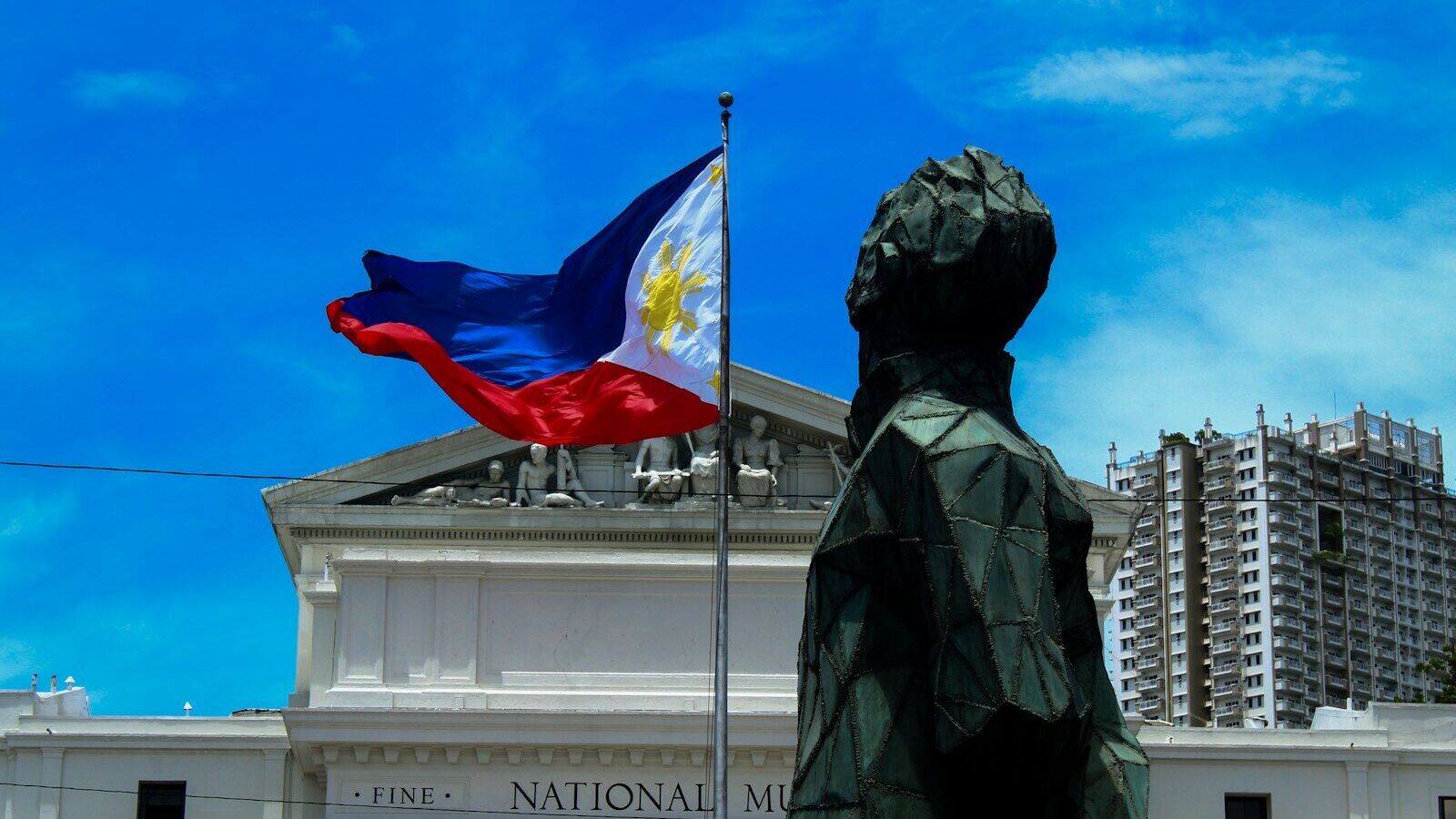 The Philippine flag waving before the National Museum of Fine Arts in Manila