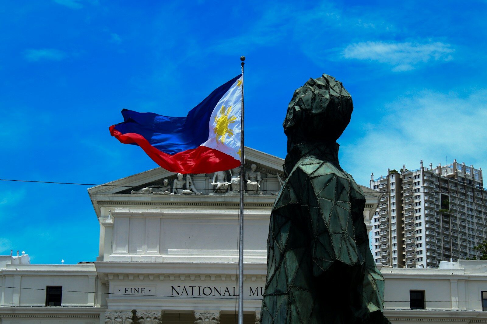 The Philippine flag waving before the National Museum of Fine Arts in Manila