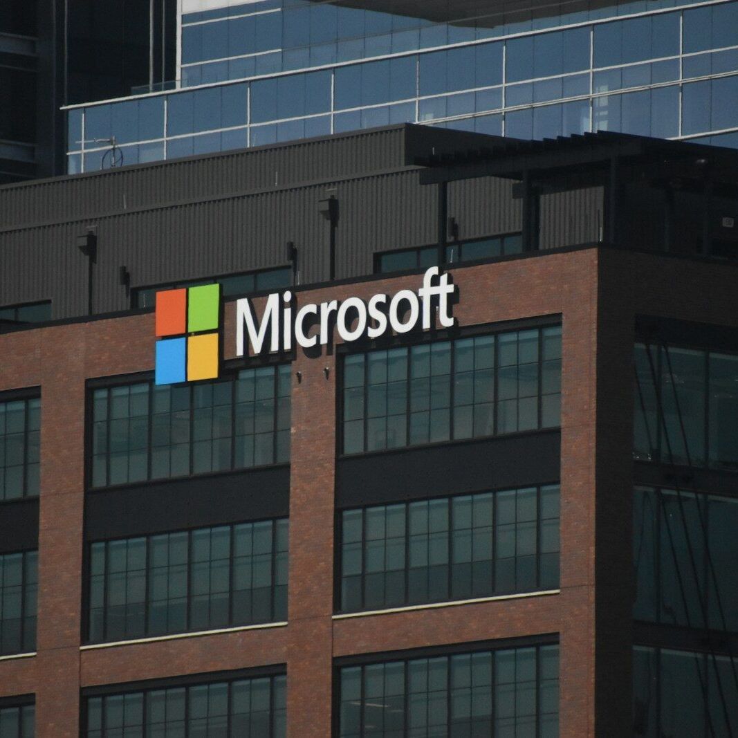 A tall building with a microsoft logo on top of it