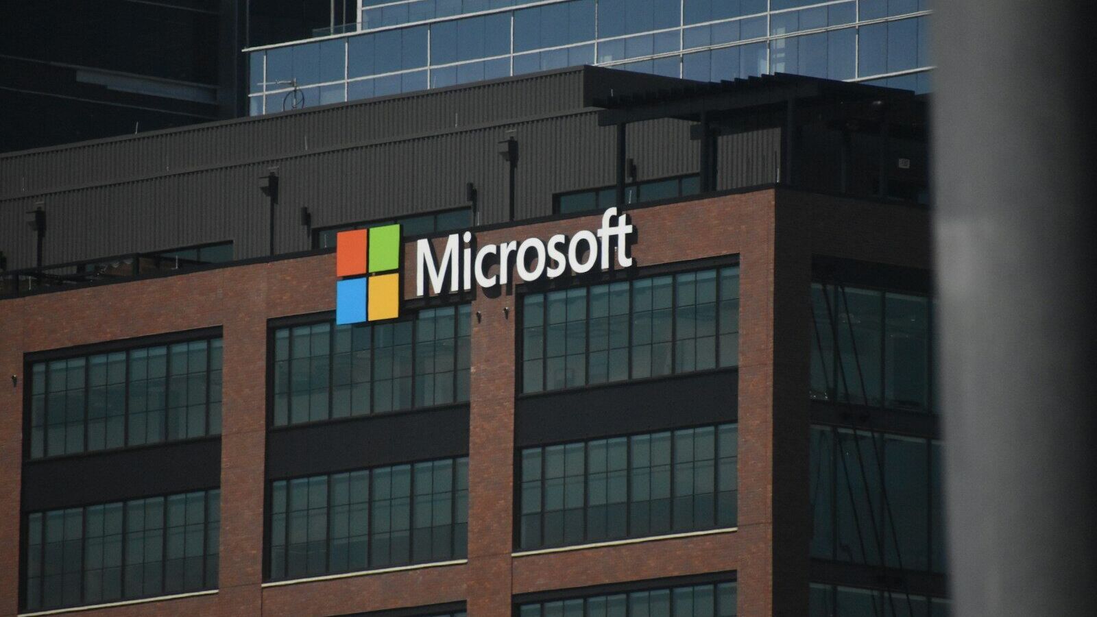 A tall building with a microsoft logo on top of it