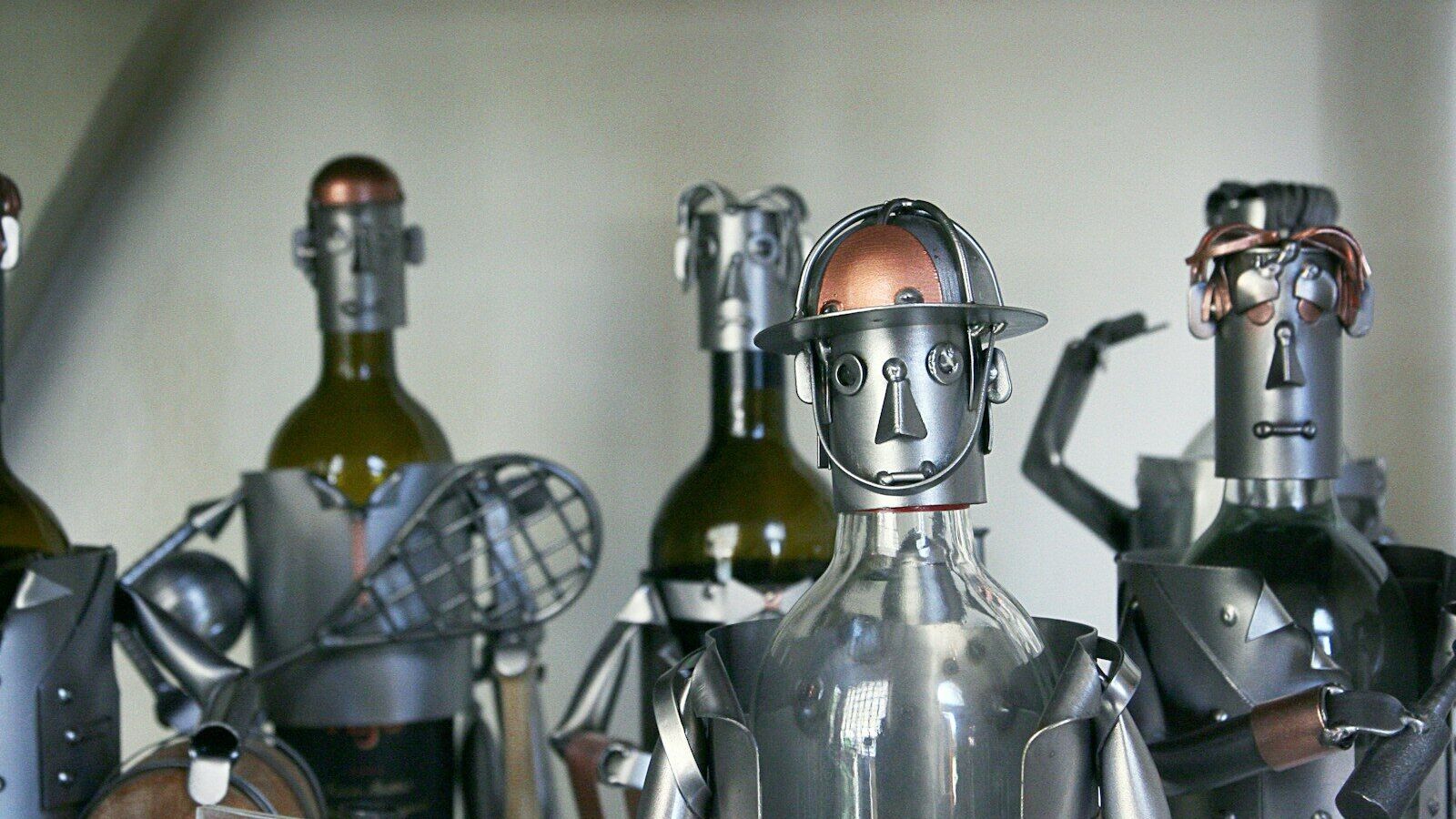 five gray-and-brown metal robots