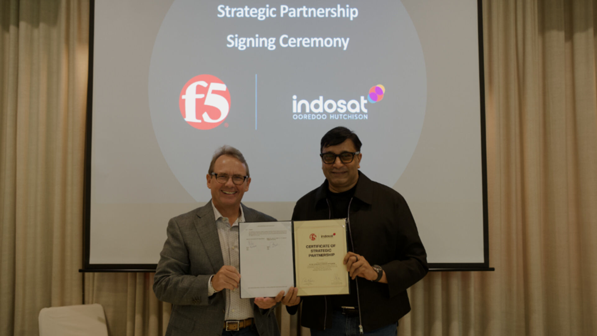 F5 and Indosat executives holding their strategic partnership certificate